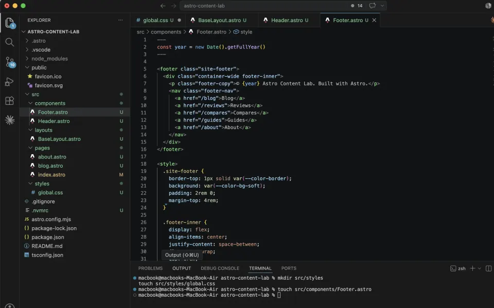 VS Code showing Footer astro with a build-time year value, footer navigation, and scoped footer CSS
